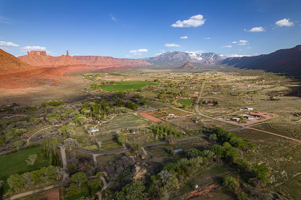 aerial taken above Castle Valley Utah showing the town, Castleton Rock, Round Mountain, and the La Sal Mountains