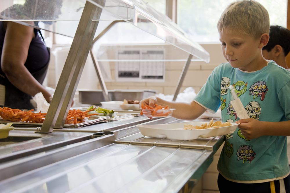 a child gets lunch at a school cafeteria